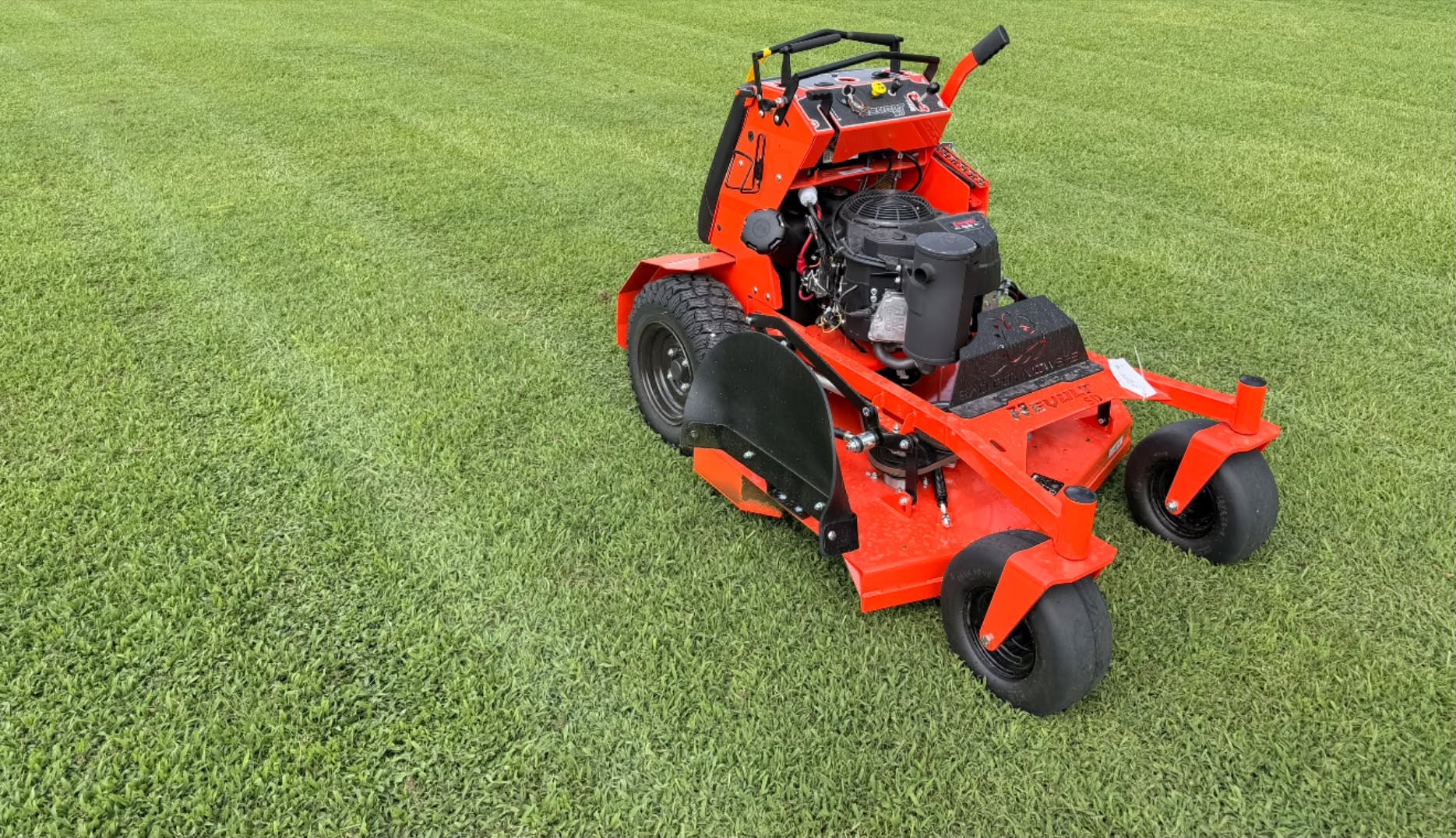 Professional red mower on a freshly cut lawn